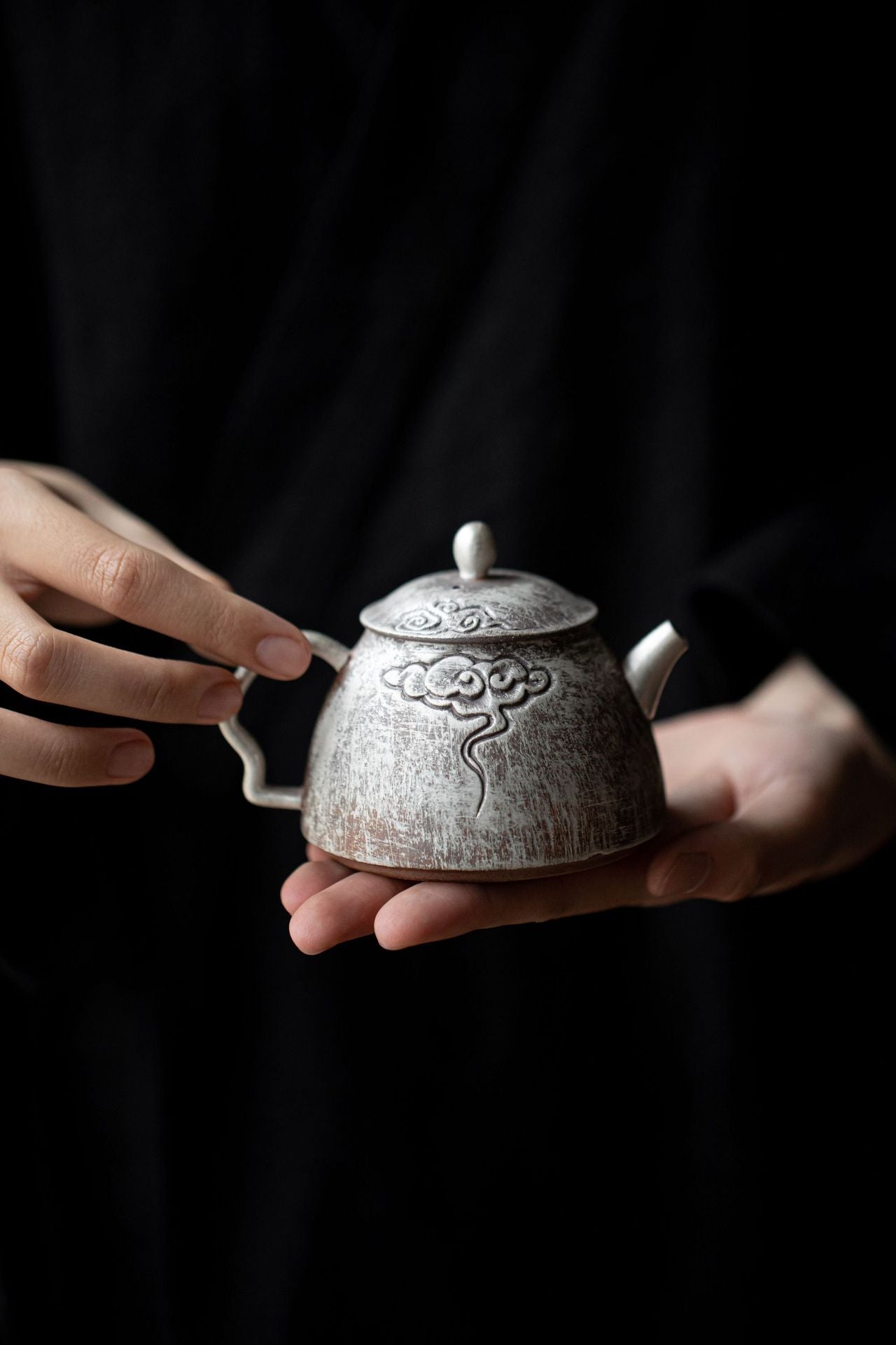 This is a gilted silver pottery teapot