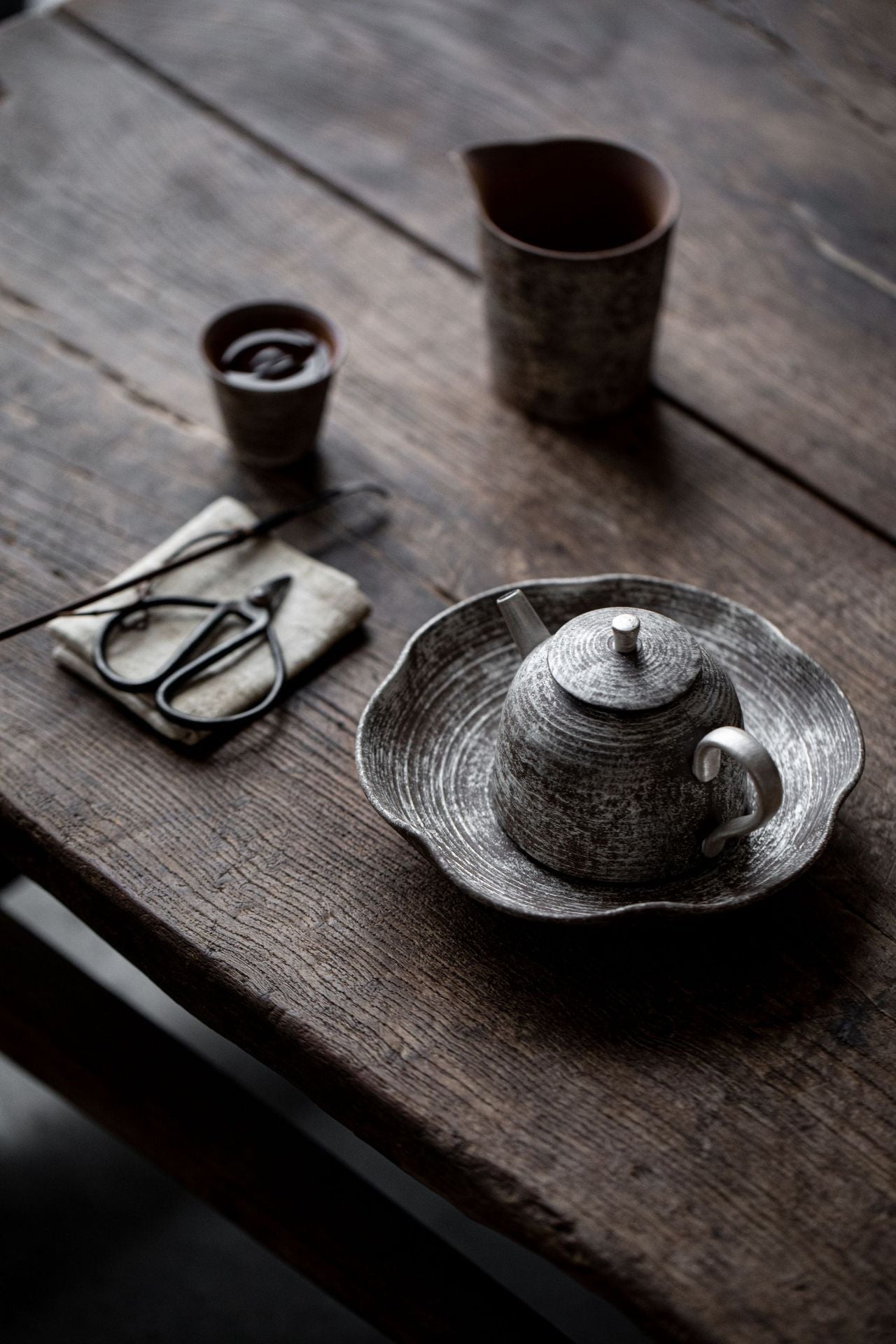 This is a gilted silver pottery teapot