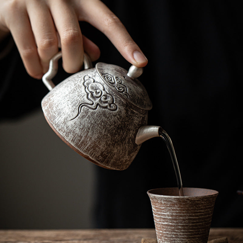 This is a gilted silver pottery teapot