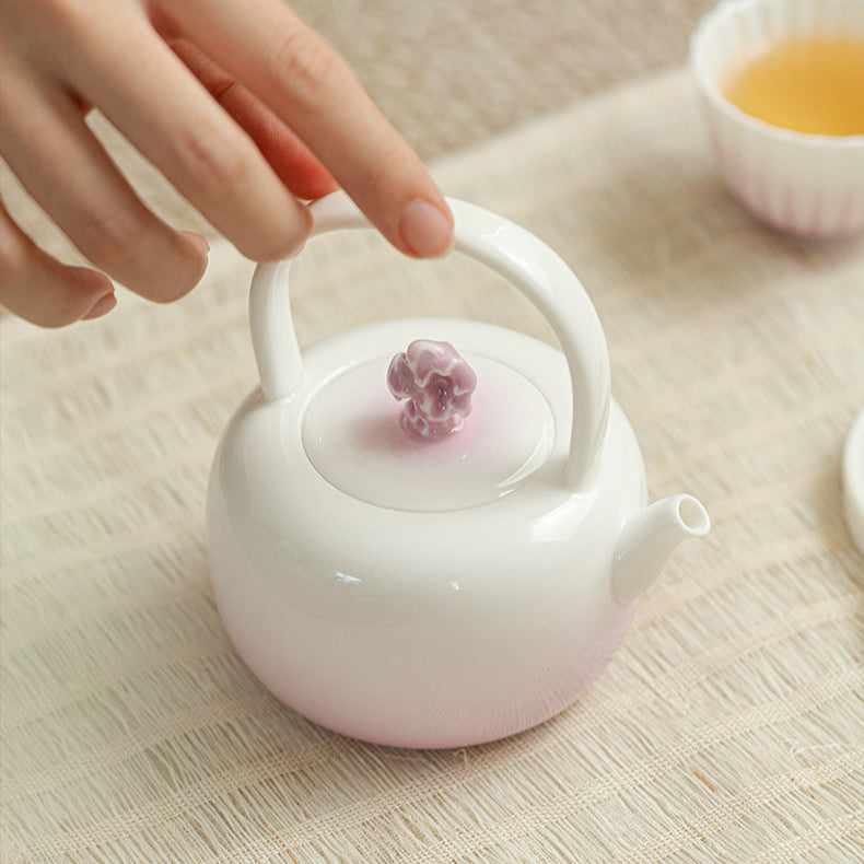 this is a purple ceramic teapot