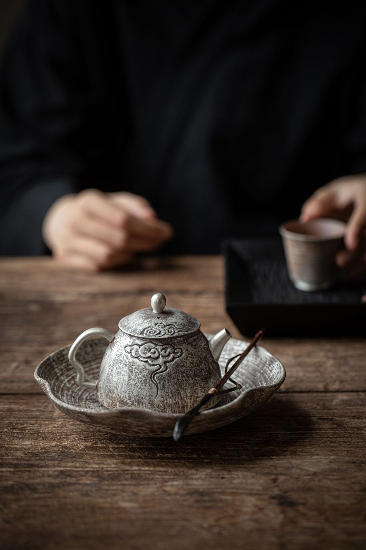This is a gilted silver pottery teapot