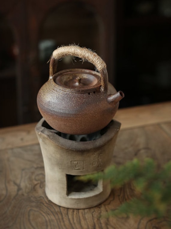 This is a pottery lifting handle kettle