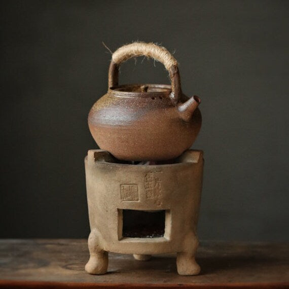 This is a pottery lifting handle kettle