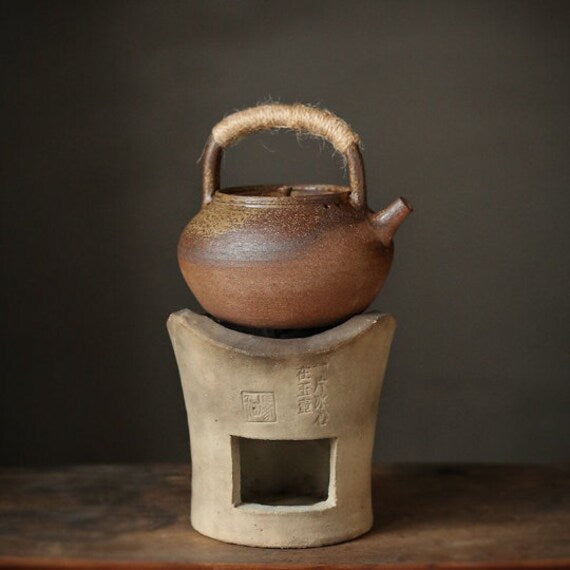 This is a pottery lifting handle kettle