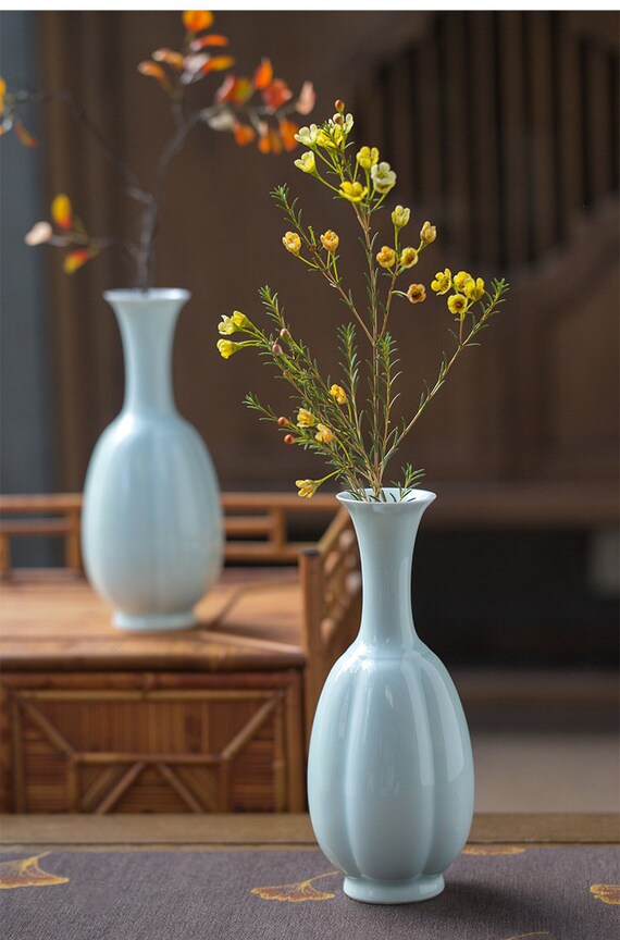 This is a celadon ceramic vase flower arrangement vessel