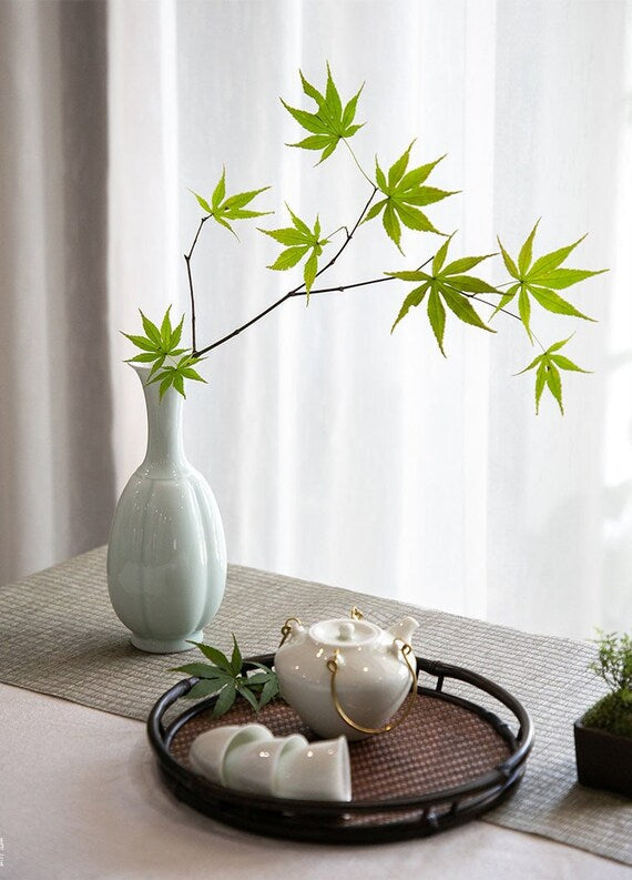 This is a celadon ceramic vase flower arrangement vessel