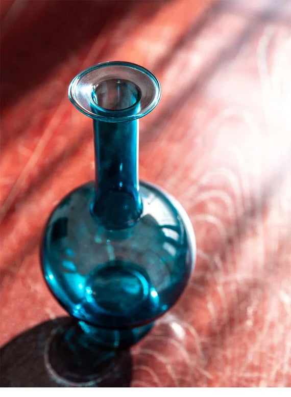 This is a blue glass vase flower arrangement vessel