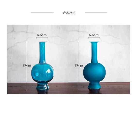 This is a blue glass vase flower arrangement vessel