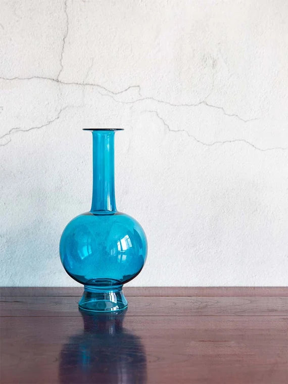 This is a blue glass vase flower arrangement vessel