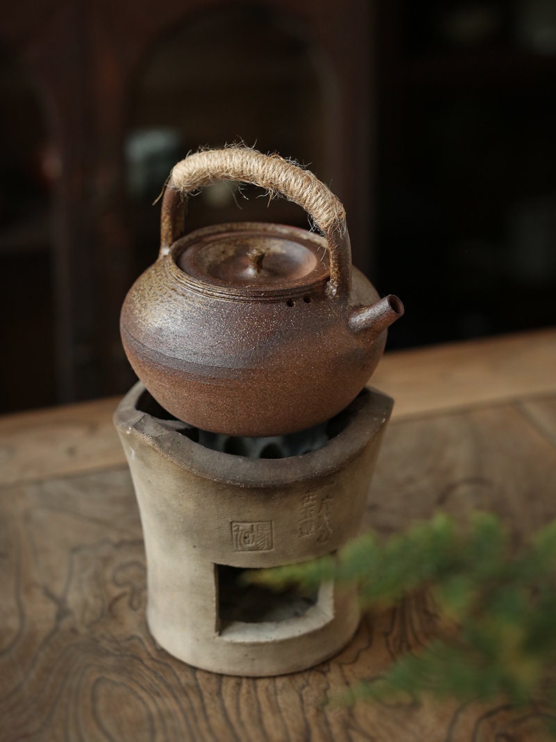 This is a pottery lifting handle kettle