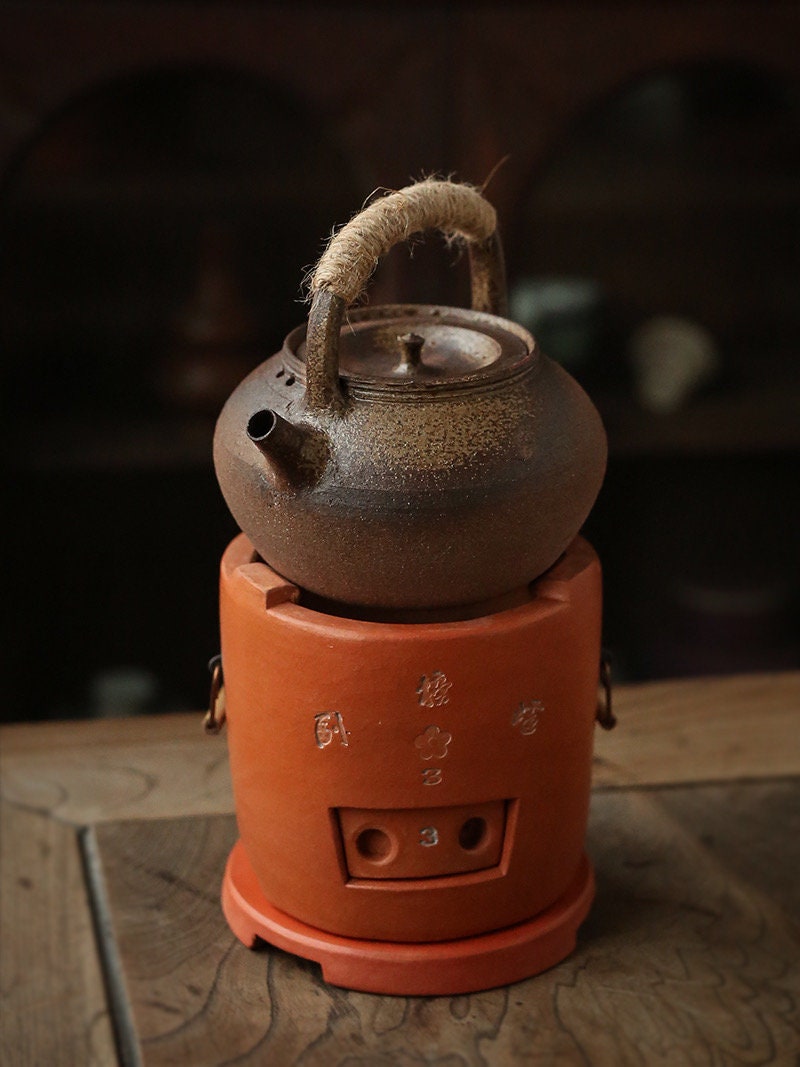 This is a pottery lifting handle kettle