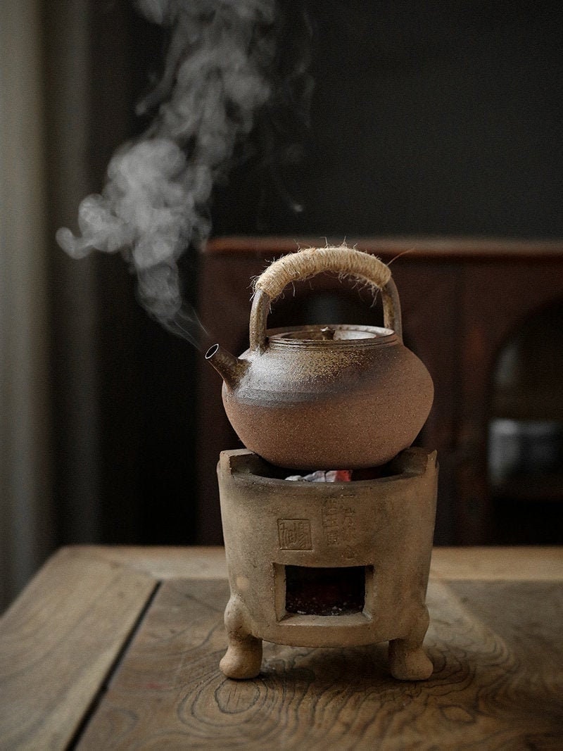 This is a pottery lifting handle kettle