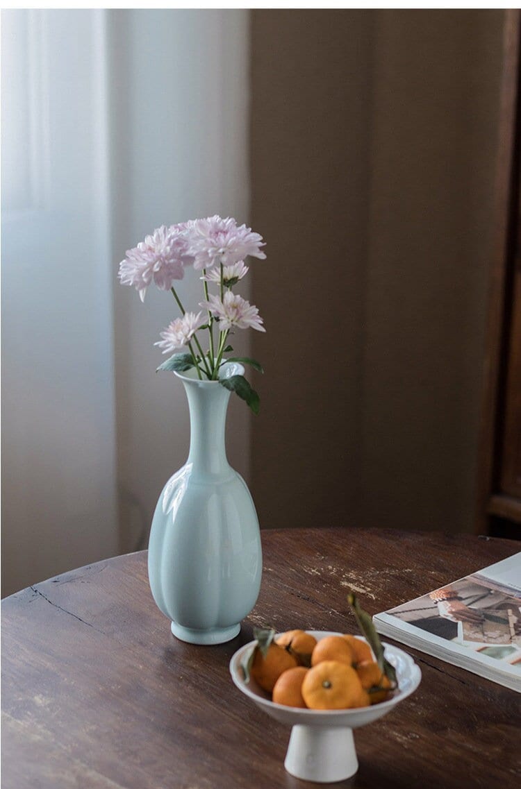 This is a celadon ceramic vase flower arrangement vessel