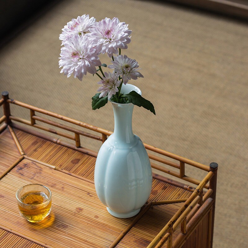This is a celadon ceramic vase flower arrangement vessel