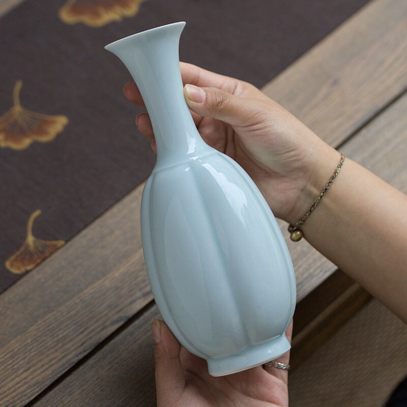 This is a celadon ceramic vase flower arrangement vessel