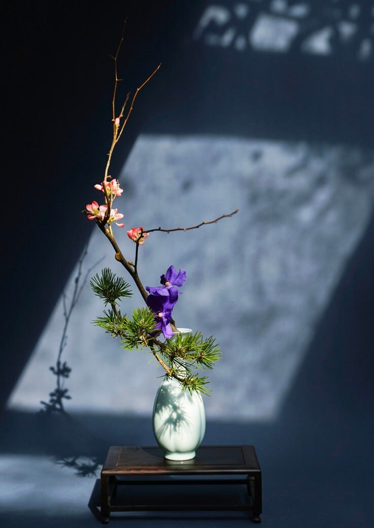 This is a celadon ceramic vase flower arrangement vessel