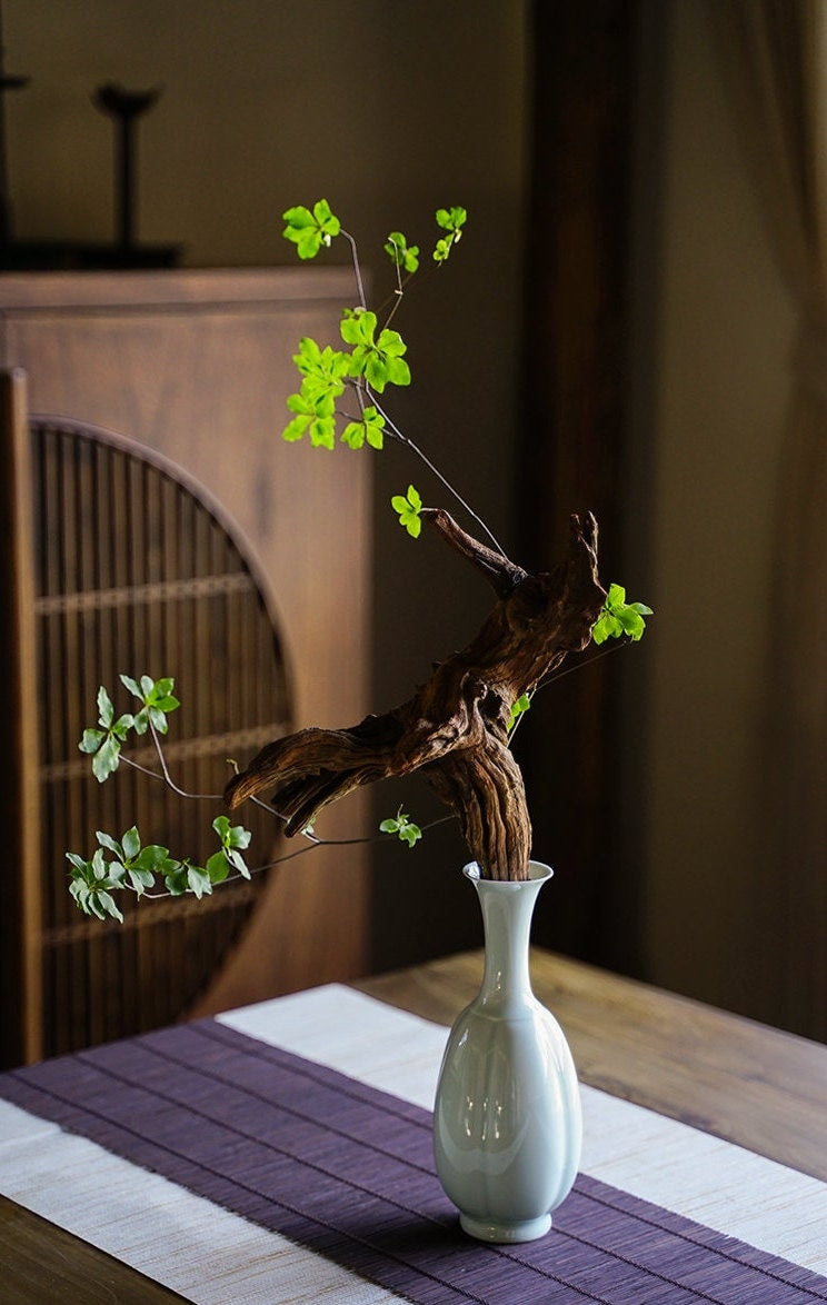 This is a celadon ceramic vase flower arrangement vessel