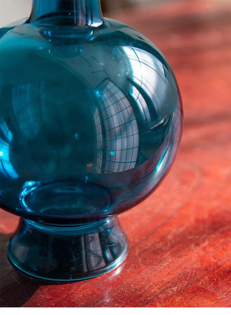 This is a blue glass vase flower arrangement vessel