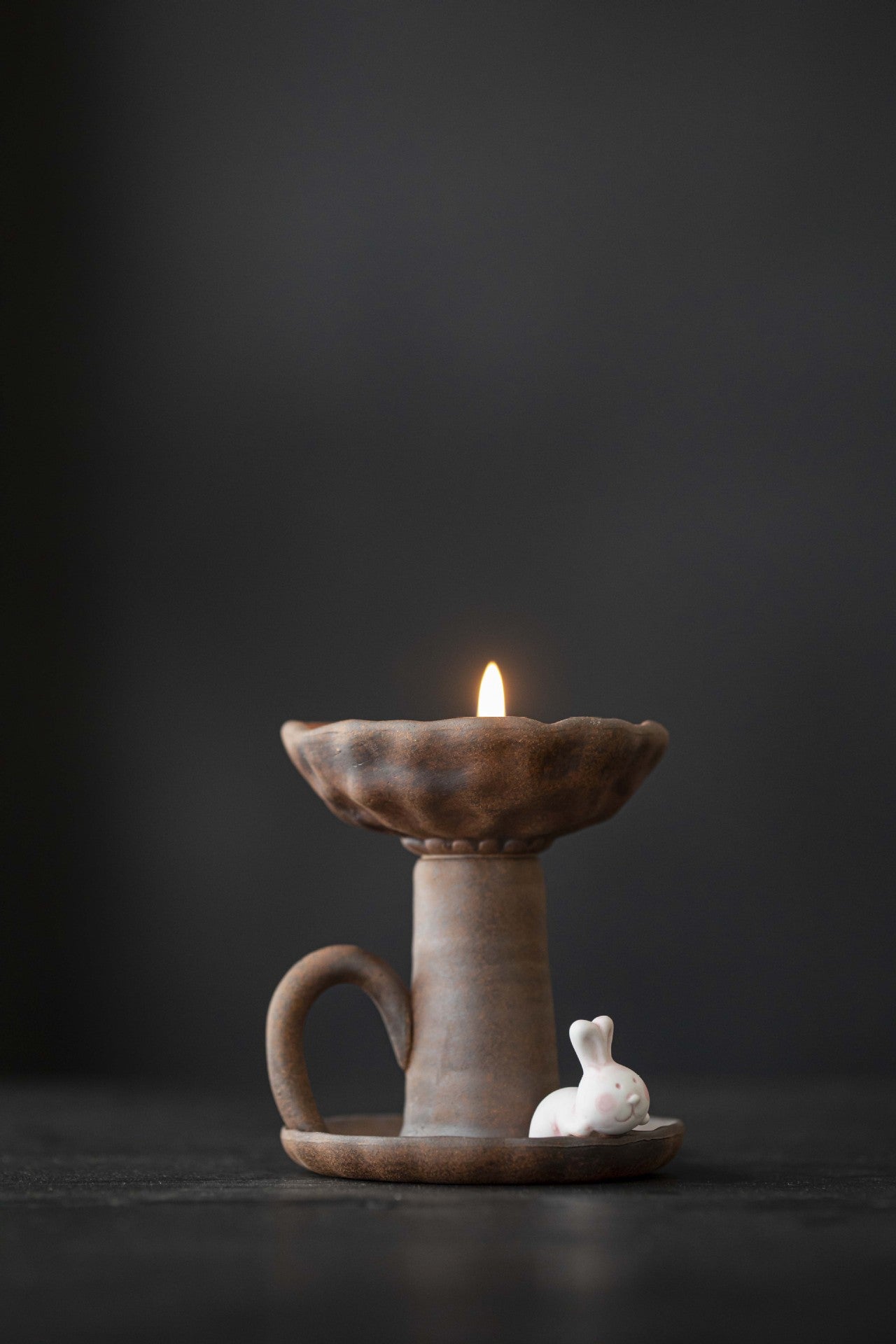 This is a pottery candlestick candle holder