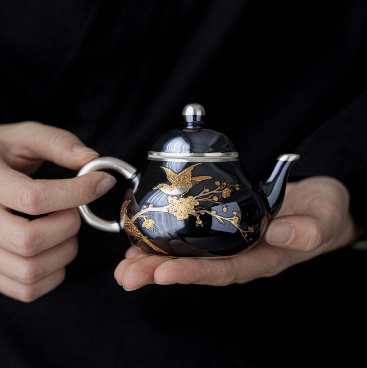 this is a ceramic teapot. this is a gilded silver teapot