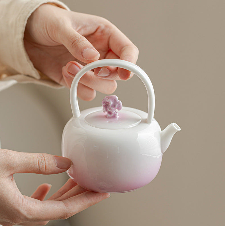 this is a ceramic purple teapot