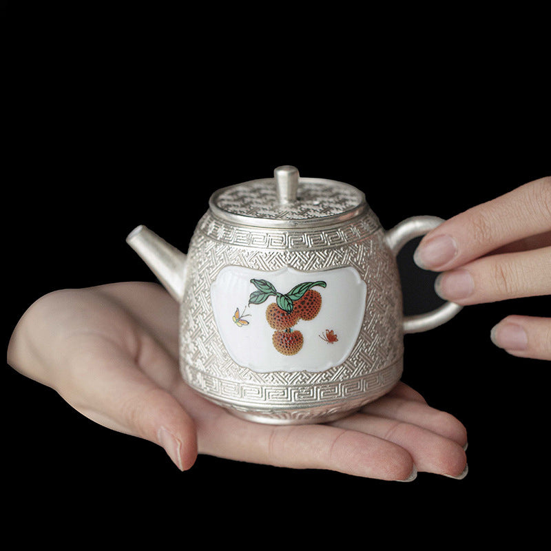 This is a gilted silver ceramic teapot