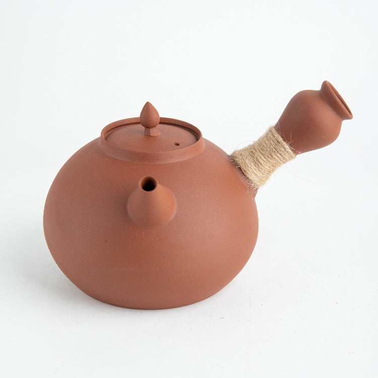 This is a pottery side handle kettle