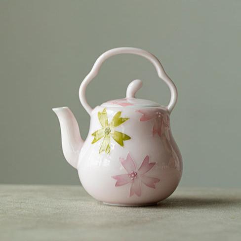 this is a pink ceramic teapot