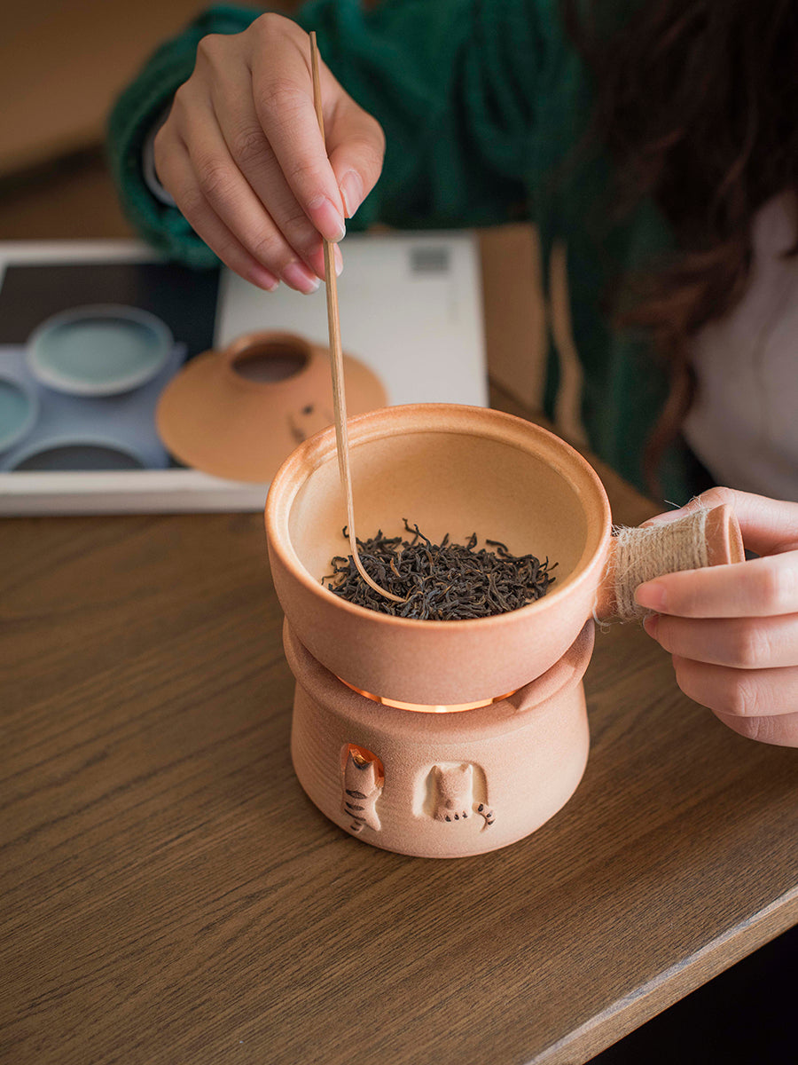 This is a pottery roasted teapot set