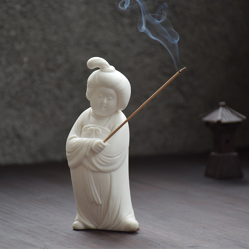 This is a white porcelain teapet incense holder