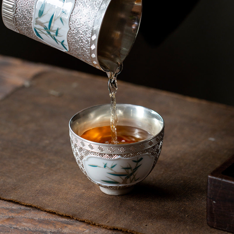 This is a gilted silver ceramic teapot