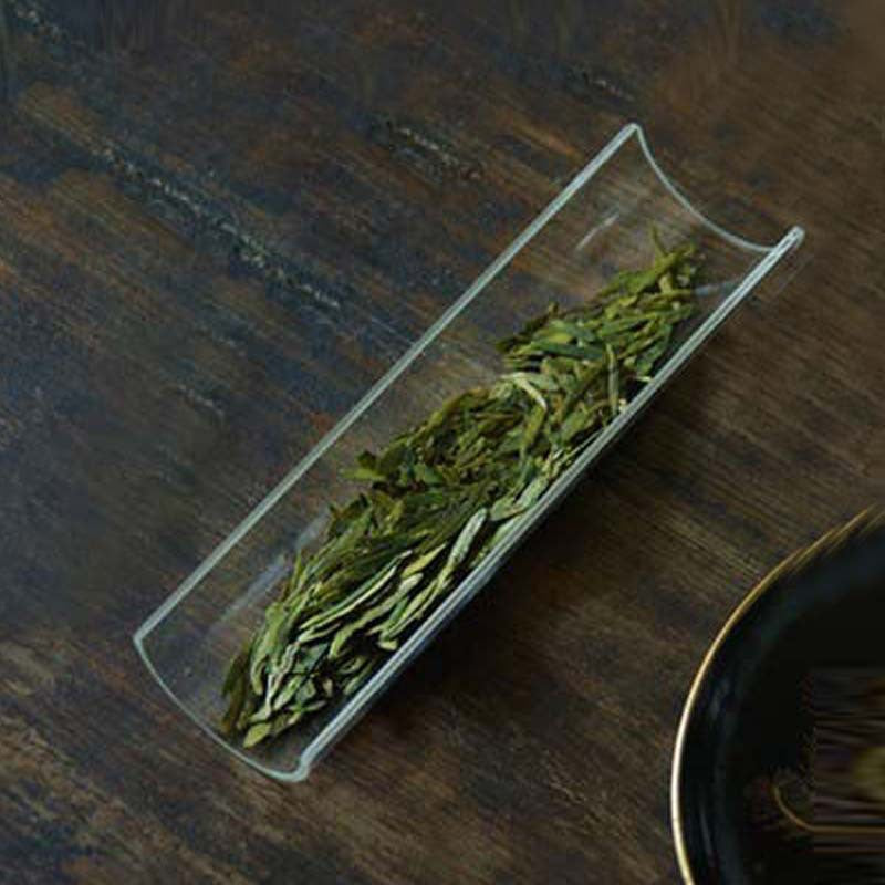 This is a glass tea scoop