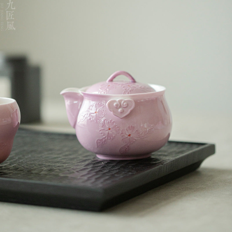 This is a Arita ware teapot. this is a pink ceramic teapot