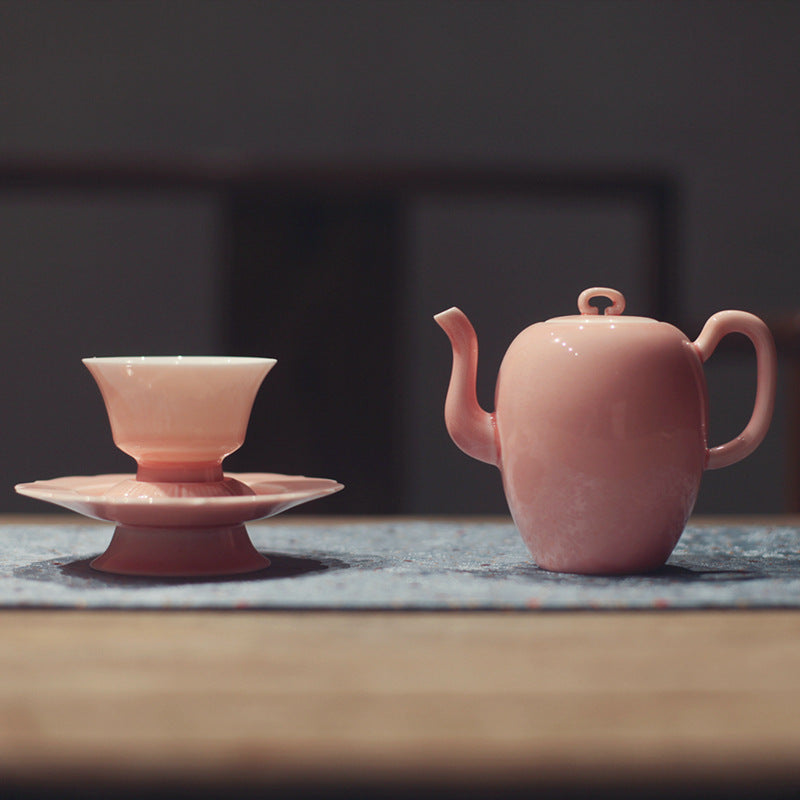 this is a pink ceramic teapot