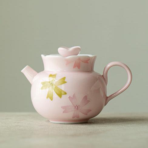 this is a pink ceramic teapot