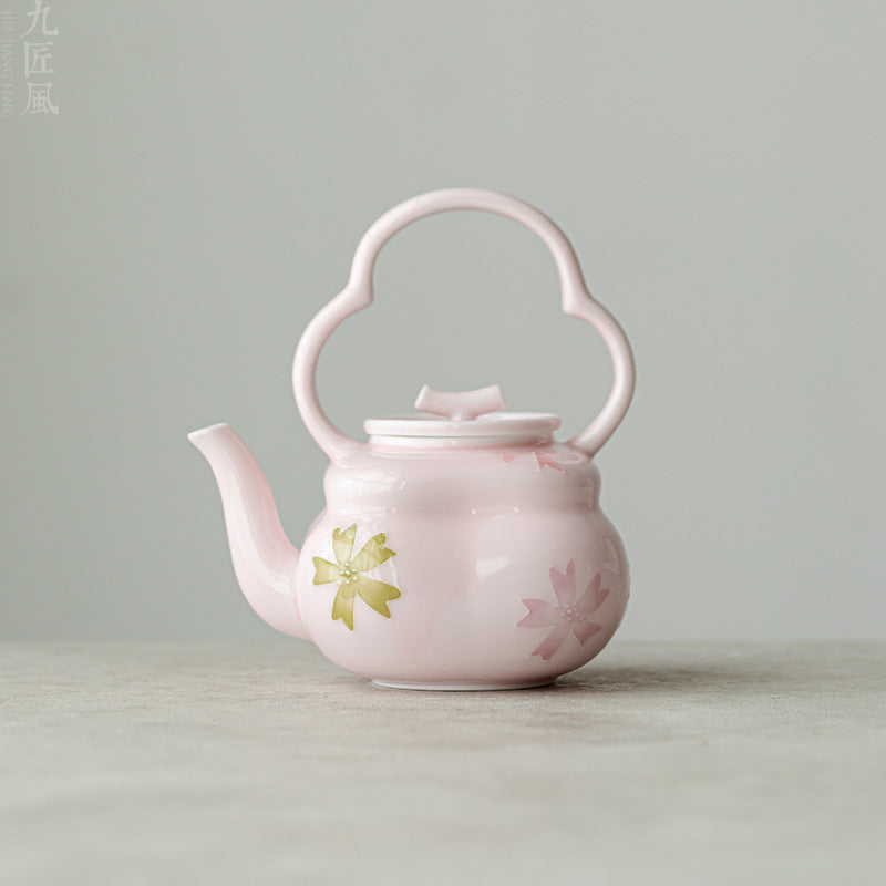 this is a pink ceramic teapot