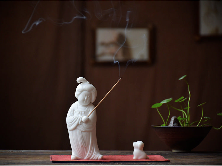 This is a white porcelain teapet incense holder