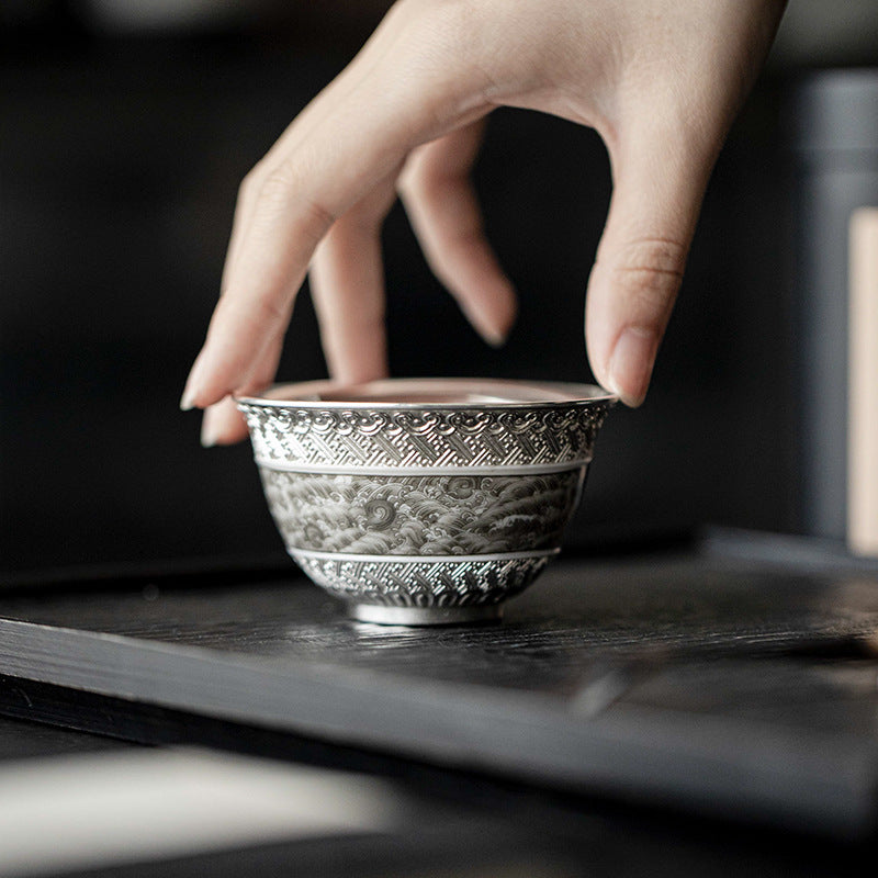 This is a gilted silver ceramic teacup