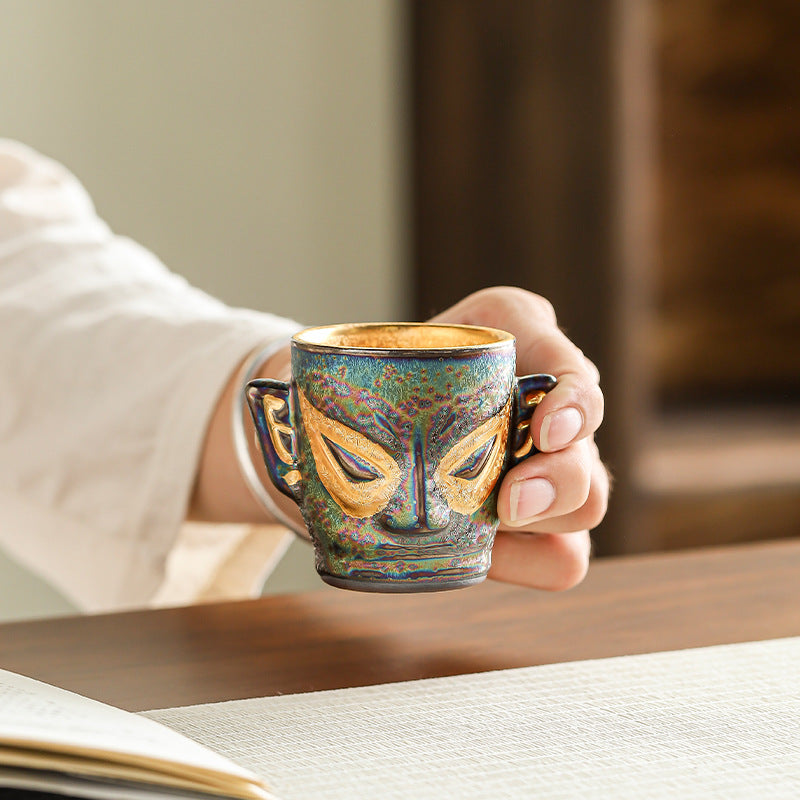 This is a gilded gold Sanxingdui teacup. this is a pottery teacup