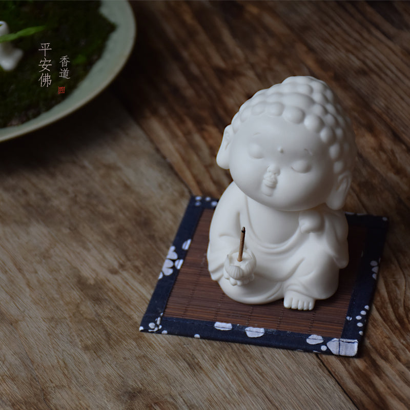 This is a white porcelain buddha teapet incense holder