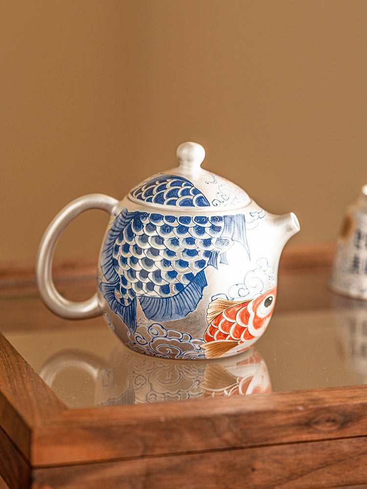  this is a gilded silver teapot. this is a ceramic teapot
