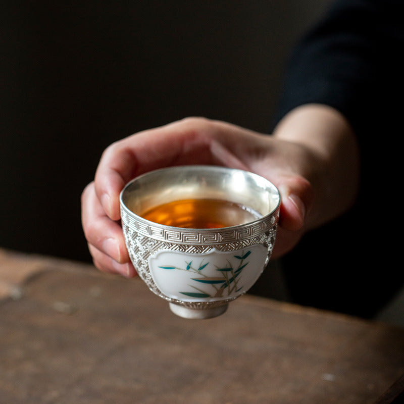 This is a gilted silver ceramic teapot