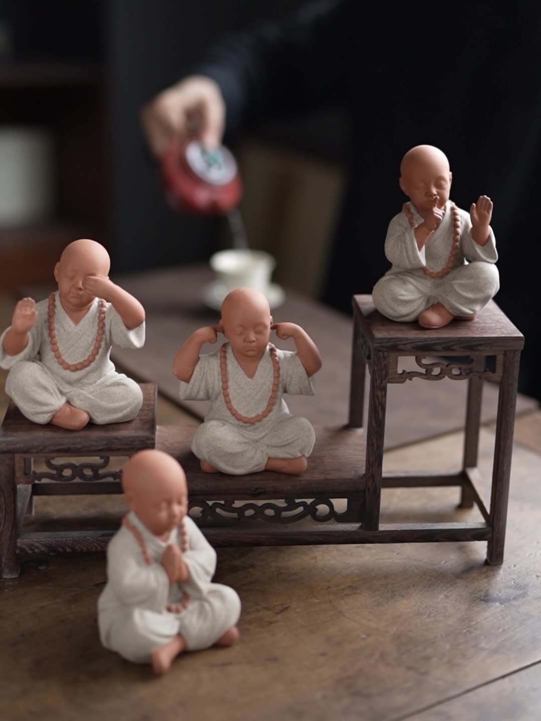 this is a mini pottery monk sculpture