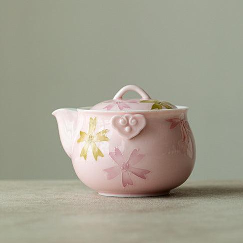 this is a pink ceramic teapot