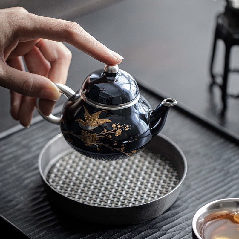 this is a ceramic teapot. this is a gilded silver teapot