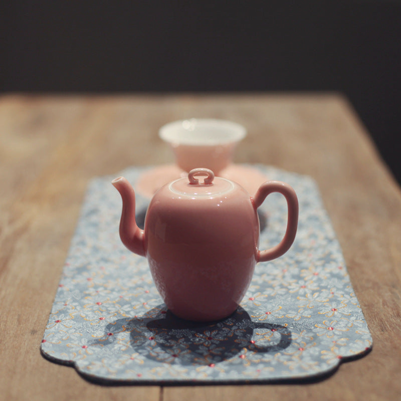 this is a pink ceramic teapot