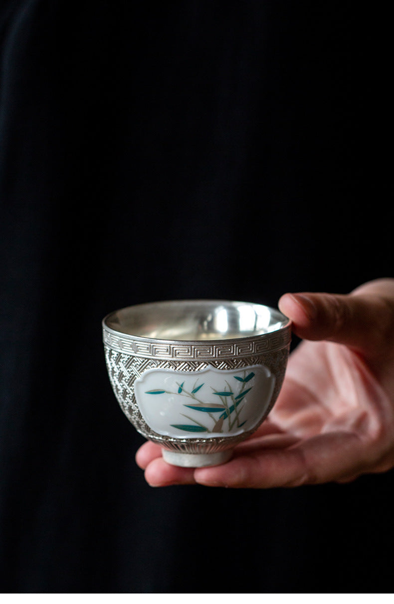 This is a gilted silver ceramic teapot