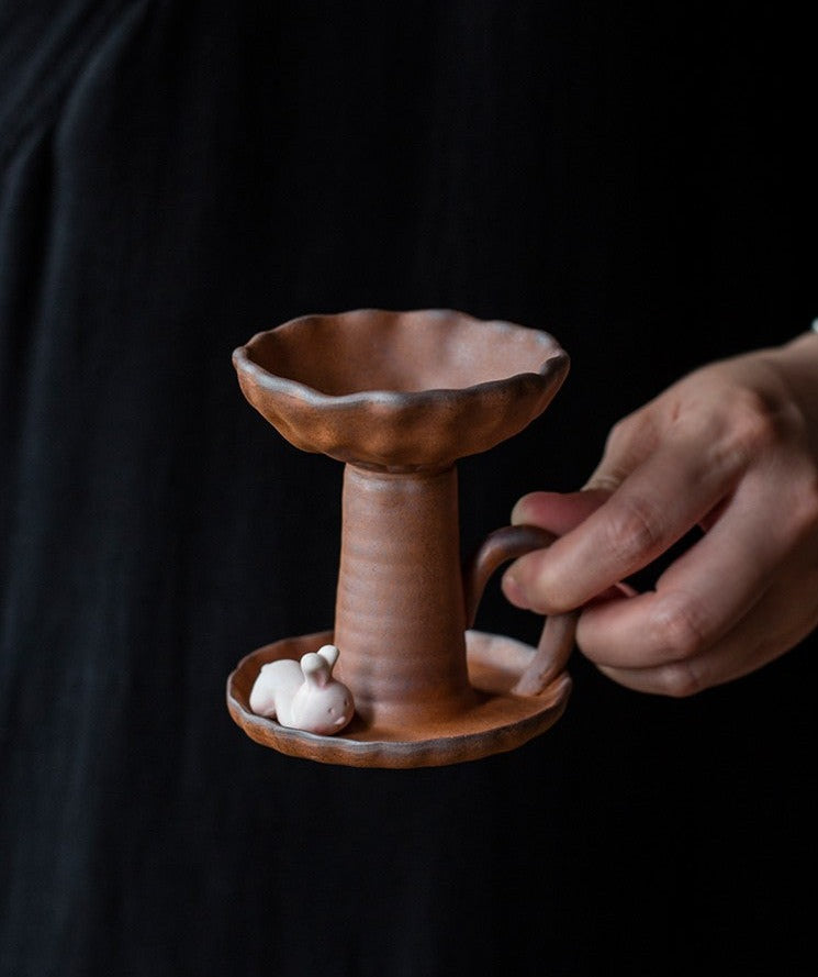 This is a pottery candlestick candle holder