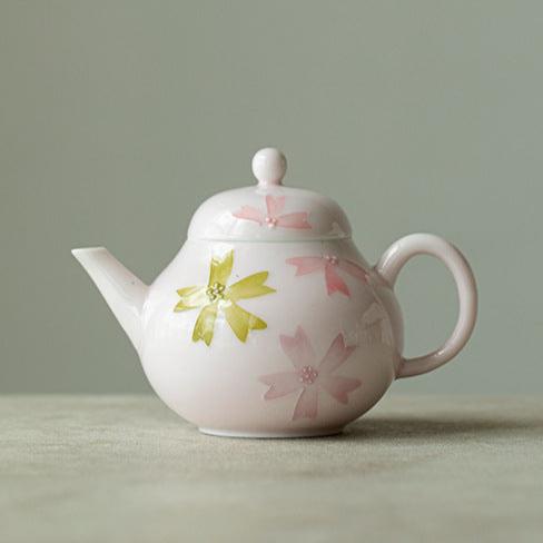 this is a pink ceramic teapot