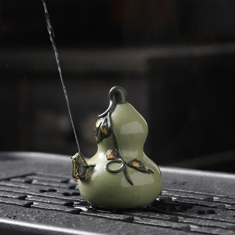 This is a Yixing purple clay water spray frog teapet